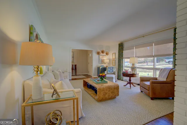 a bedroom with furniture and a large window