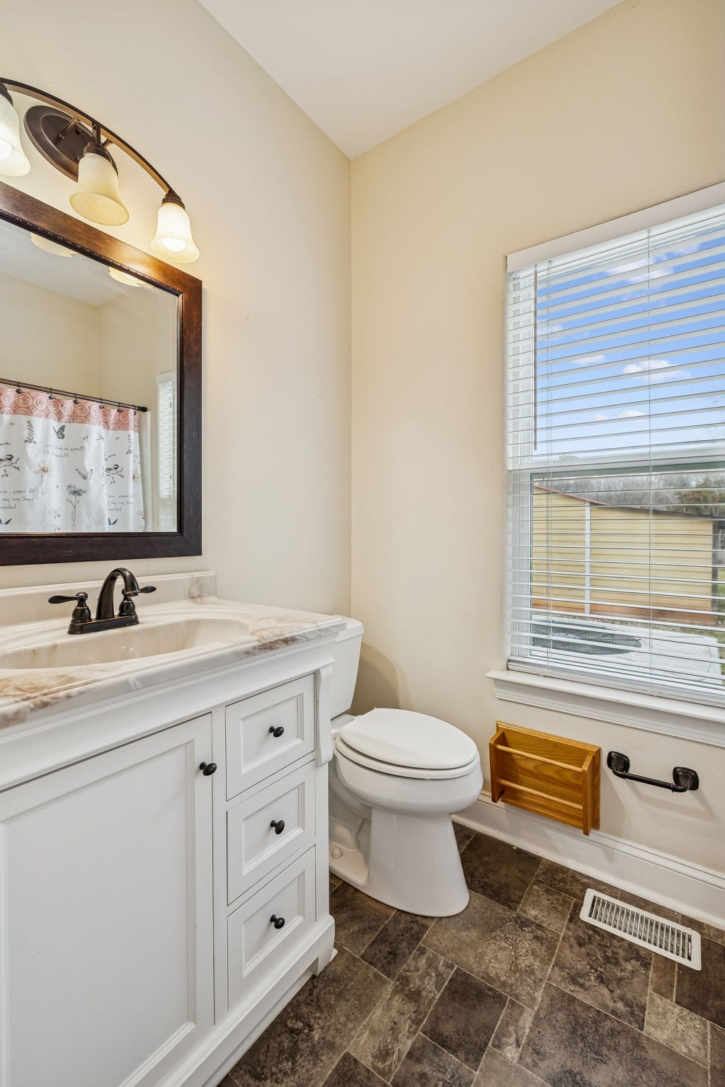 1970 Corinth Road Mount Juliet, TN 37122 - Photo 43 of 71 a bathroom with a granite countertop toilet sink and mirror