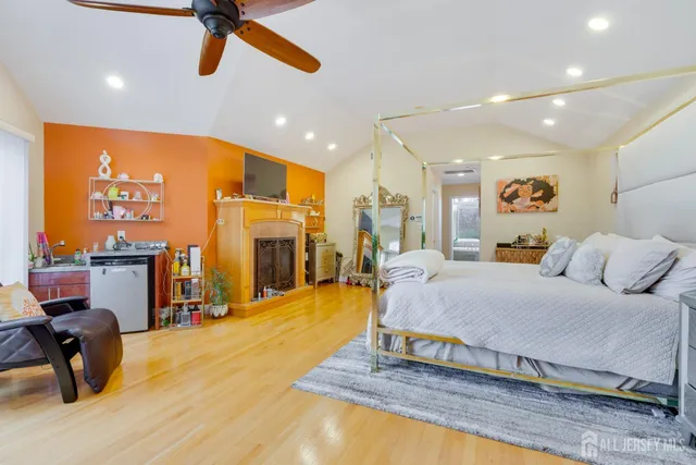 a spacious bedroom with a bed and glass table
