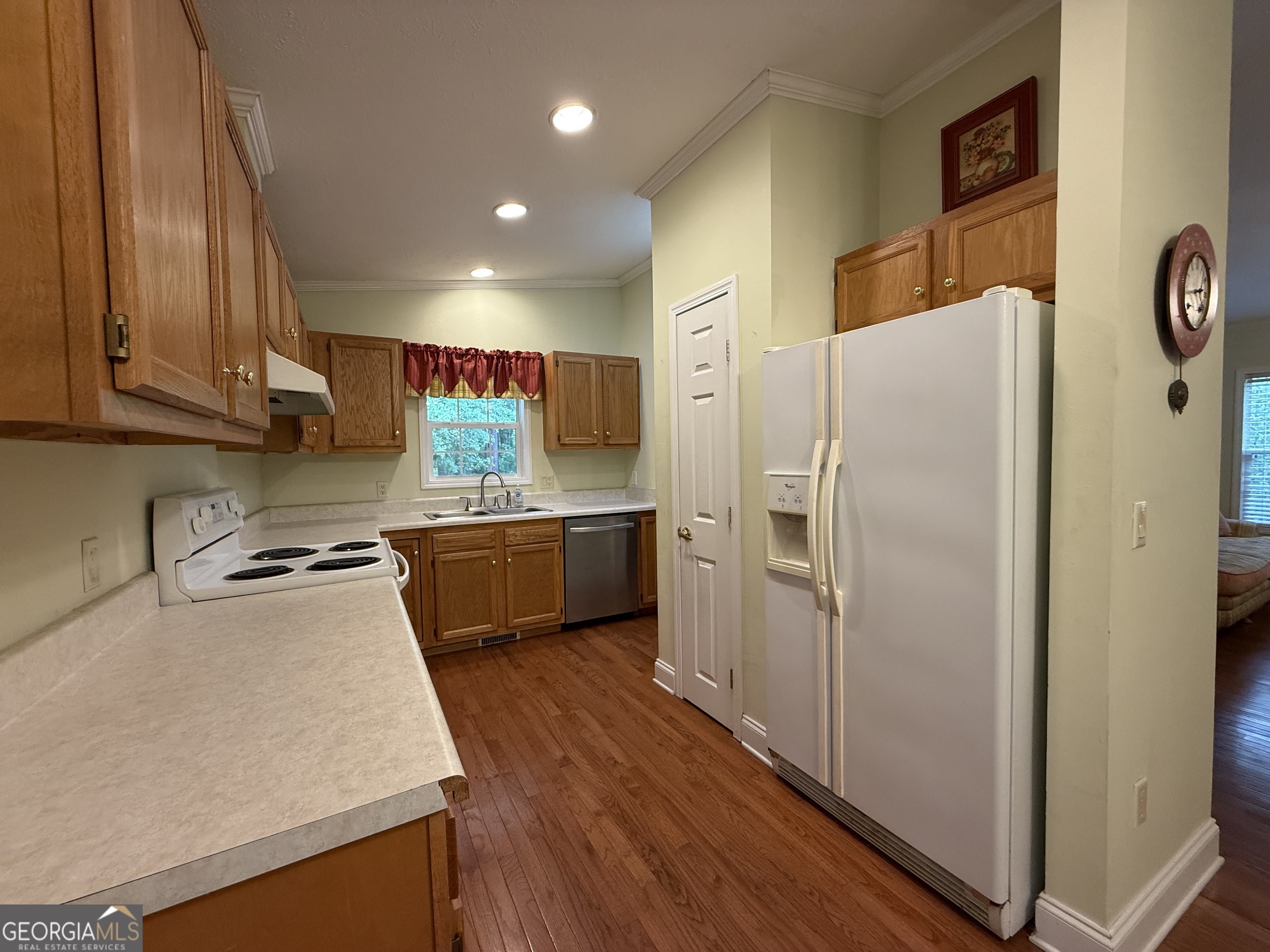 1081 Marshall Church Road Thomson, GA 30824 - Photo 10 of 26 a kitchen with a refrigerator a sink and a stove