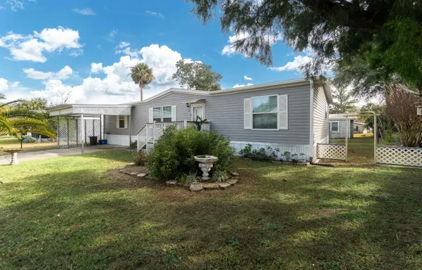 a view of a house with a backyard