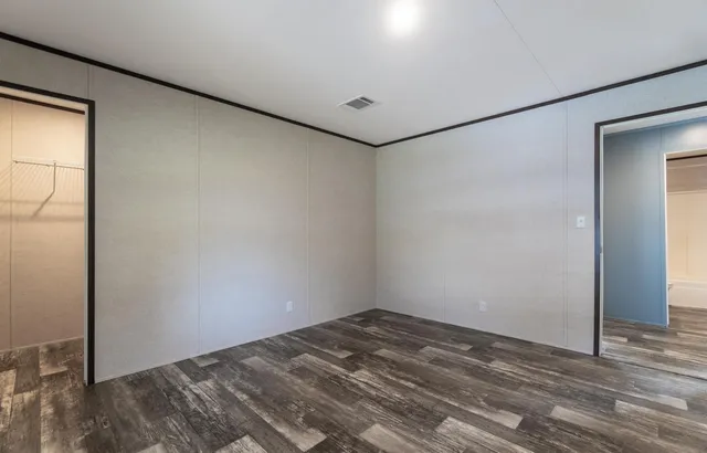 a view of a room with wooden floor