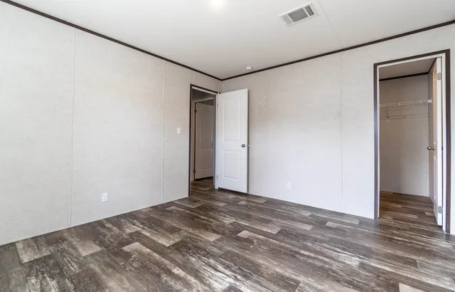a view of a room with wooden floor