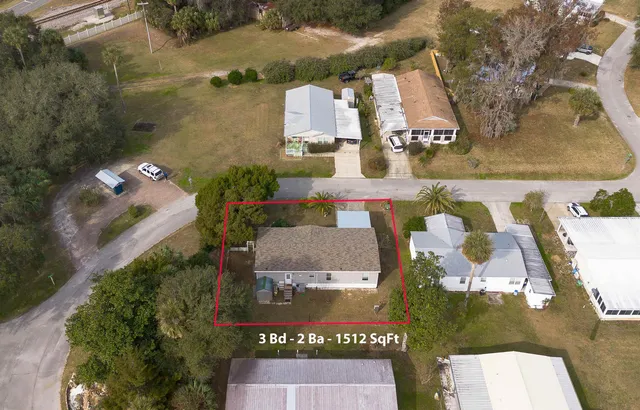 an aerial view of residential houses with outdoor space
