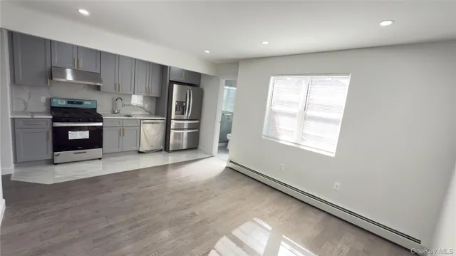 a kitchen with stainless steel appliances a refrigerator and a stove top oven