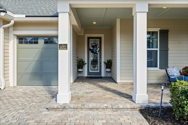 a living room with furniture and a view of kitchen