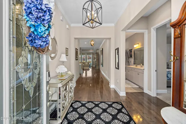 a living room with furniture and a view of kitchen
