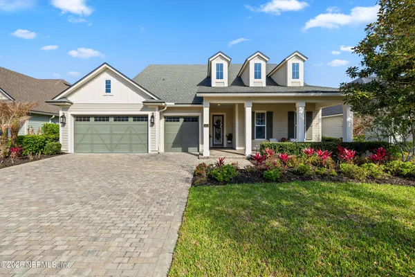 a view of a house with a big yard and potted plants