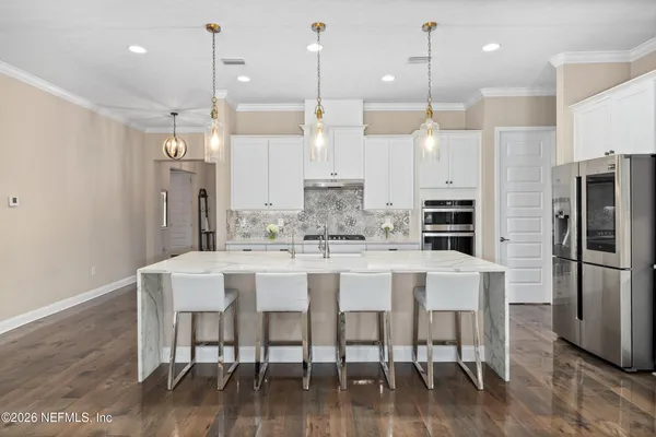 a spacious bathroom with a granite countertop sink a mirror and a