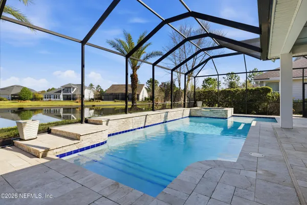 a view of a patio with table and chairs under an umbrella