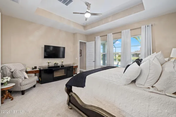 a view of a house with swimming pool and sitting area