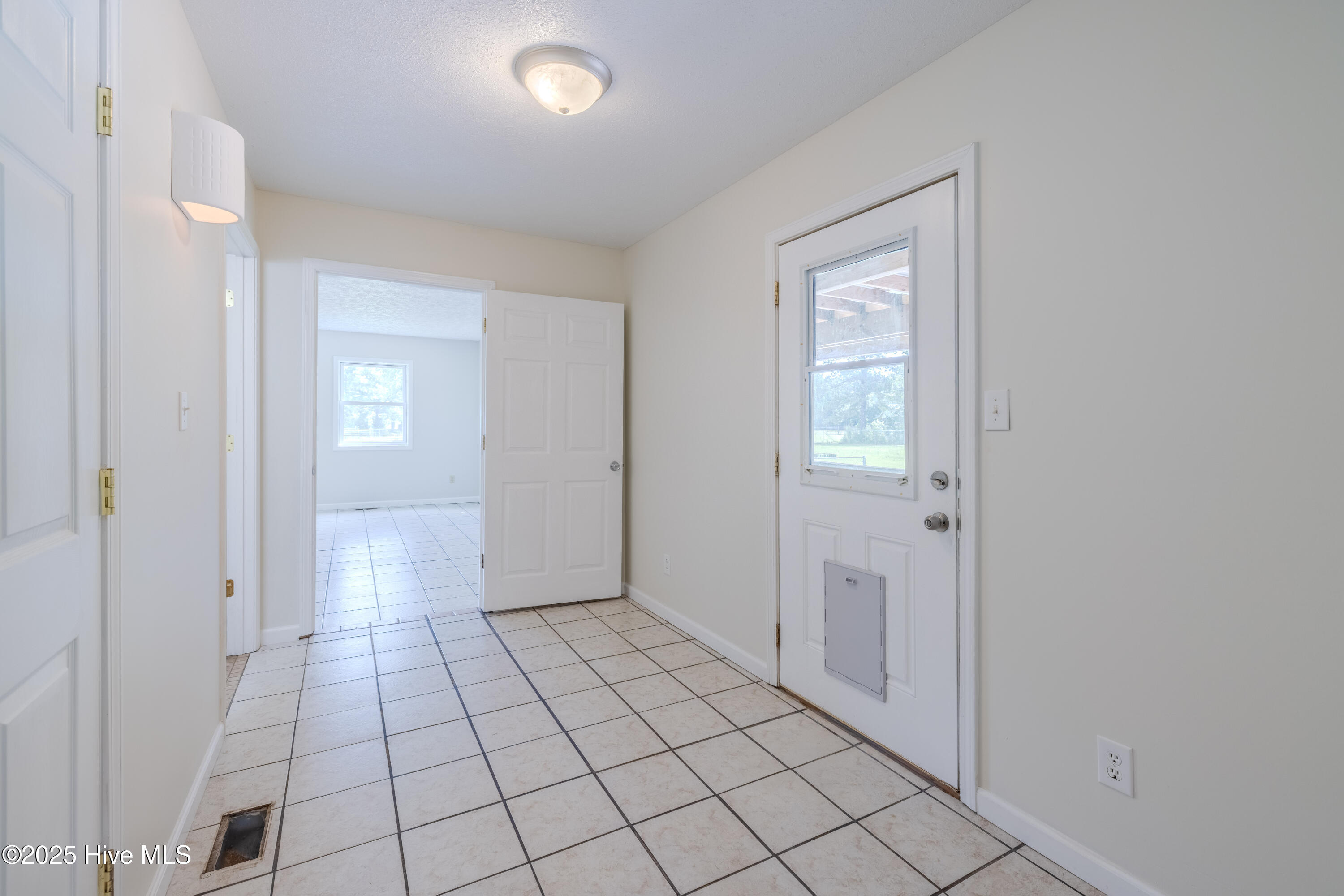 161 Howard Lane Swansboro, NC 28584 - Photo 22 of 56 This bedroom provides access to the back wrap-around porch for morning coffee out of doors.