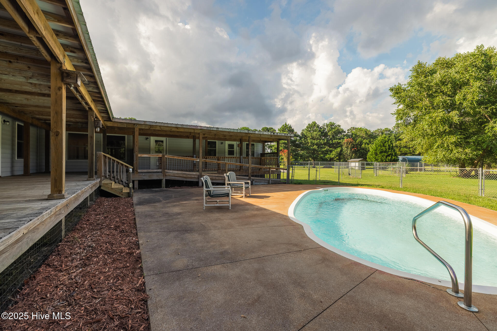 161 Howard Lane Swansboro, NC 28584 - Photo 23 of 56 In-ground saltwater pool nestled between the two wings of the home.