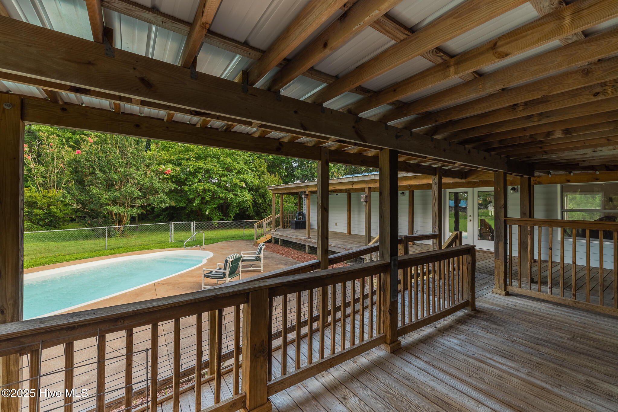 161 Howard Lane Swansboro, NC 28584 - Photo 24 of 56 Features of the wrap around back porch include ramp and gate, shade-roof, and a view of the pool.