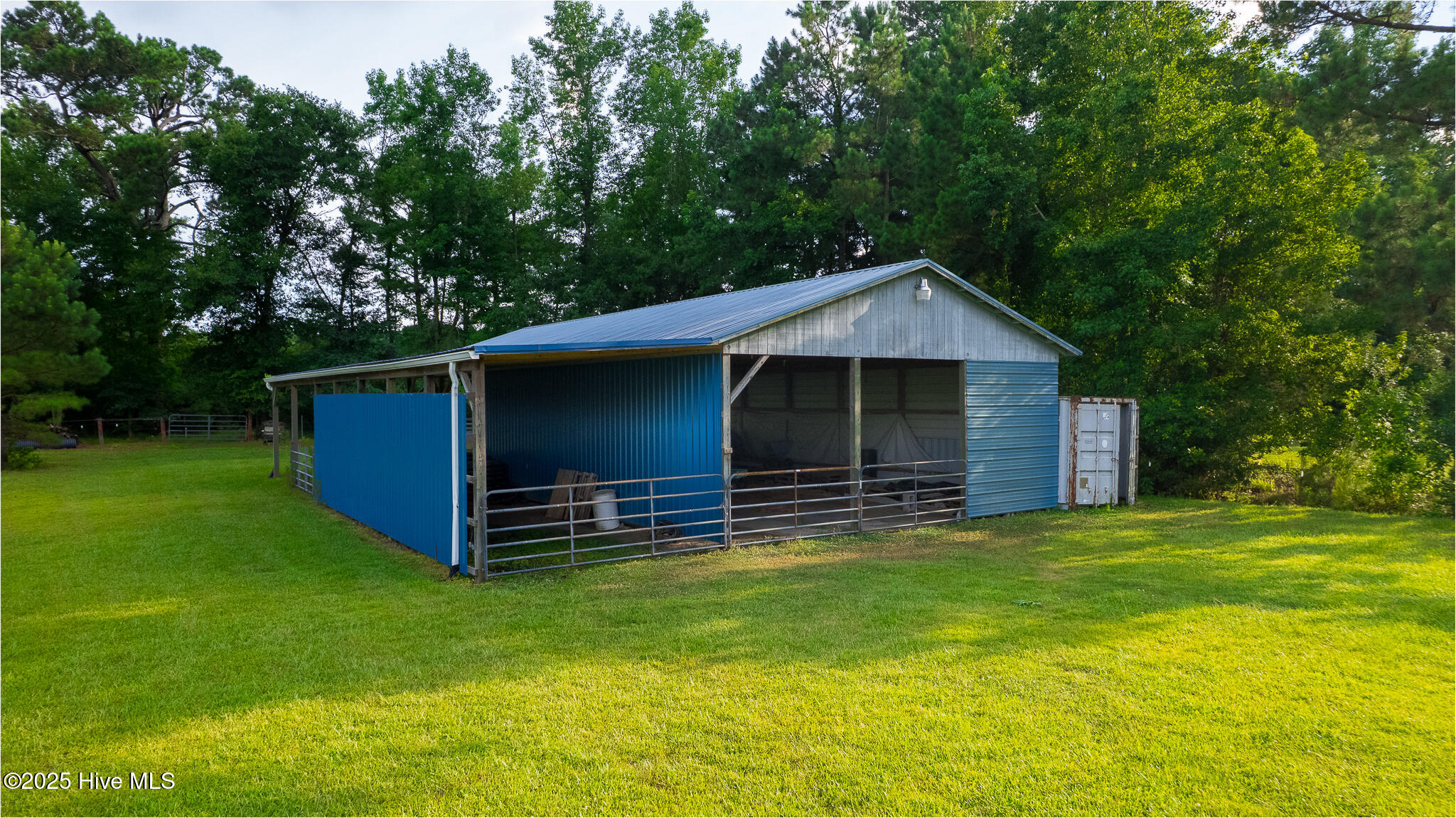 161 Howard Lane Swansboro, NC 28584 - Photo 31 of 56 Partial walls for additional protection from weather for equipment or animals. Note sea container on right - one of 2 on the property, with circulating fans. Snug for longer term hay storage.