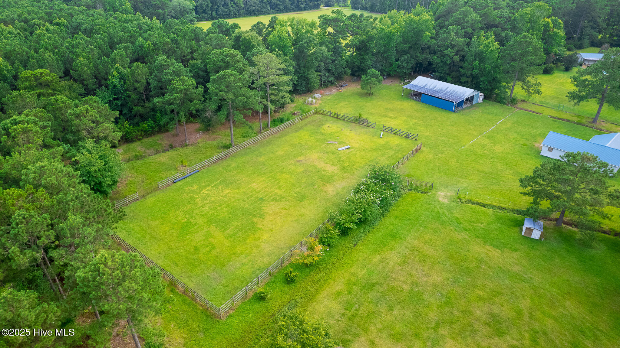 161 Howard Lane Swansboro, NC 28584 - Photo 32 of 56 Training paddock (left half of photo) near stable and one of the pole barns (right side of photo).