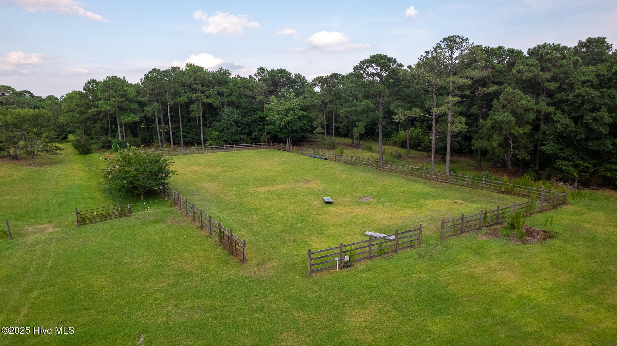 161 Howard Lane Swansboro, NC 28584 - Photo 33 of 56 One gate oriented to stable and the other opens to the northernmost pasture. All fencing in excellent condition. Horse obstacles throughout the property are included in the sale.