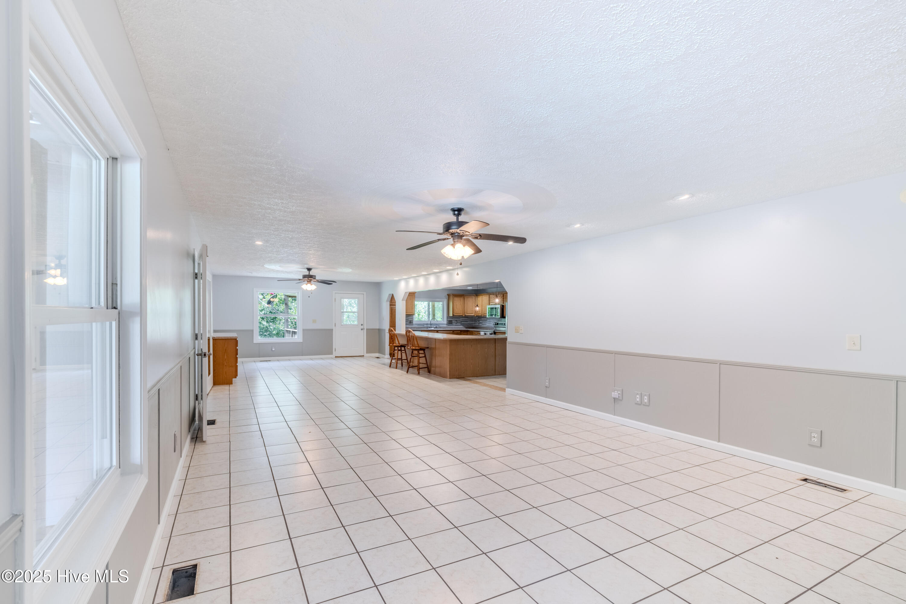 161 Howard Lane Swansboro, NC 28584 - Photo 40 of 56 Expansive dining and entertaining room spans nearly across entire front wing of home.