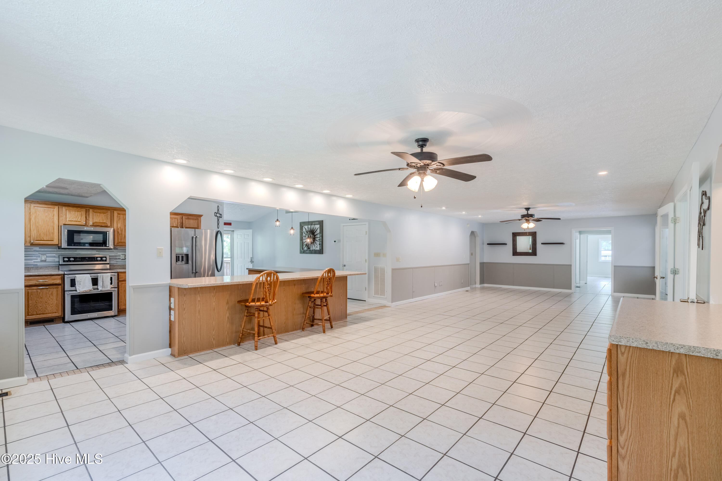 161 Howard Lane Swansboro, NC 28584 - Photo 42 of 56 Open concept kitchen with bar seating aroung L-shaped outer countertop.