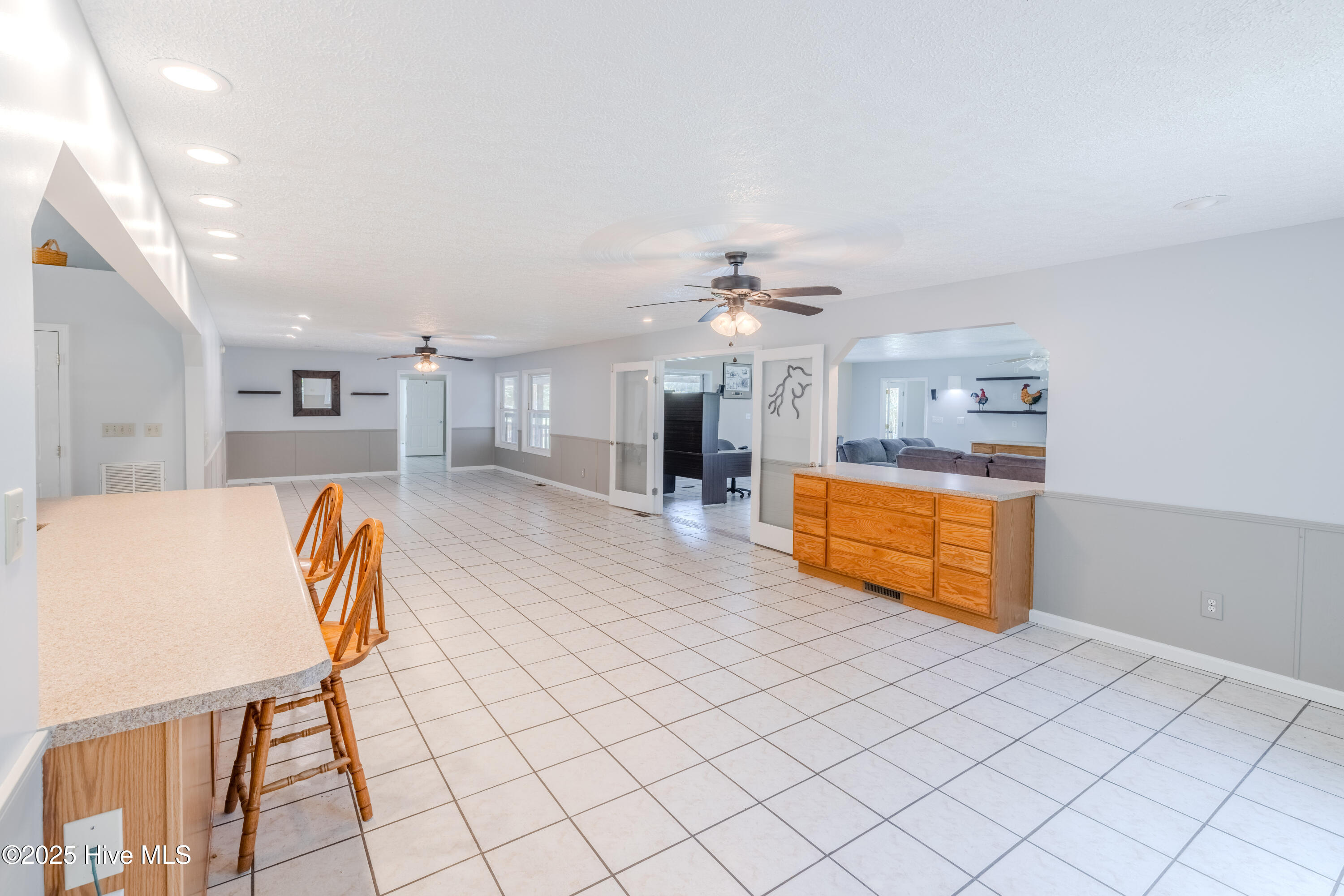 161 Howard Lane Swansboro, NC 28584 - Photo 44 of 56 Kitchen and dining spaces comminicate with family room through doorway and cut-out above side bar.