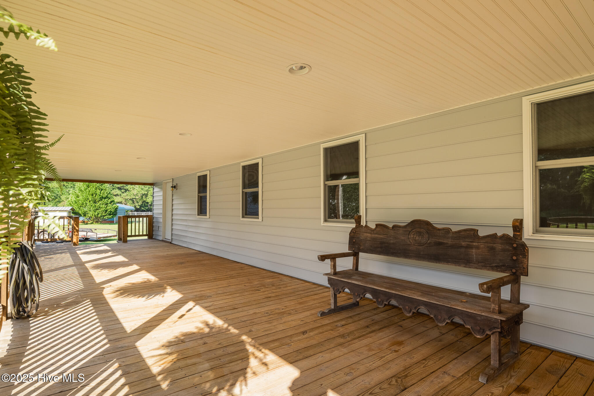 161 Howard Lane Swansboro, NC 28584 - Photo 4 of 56 Deep front porches shade the windows and reduce energy bills. (Bench does not convey.)