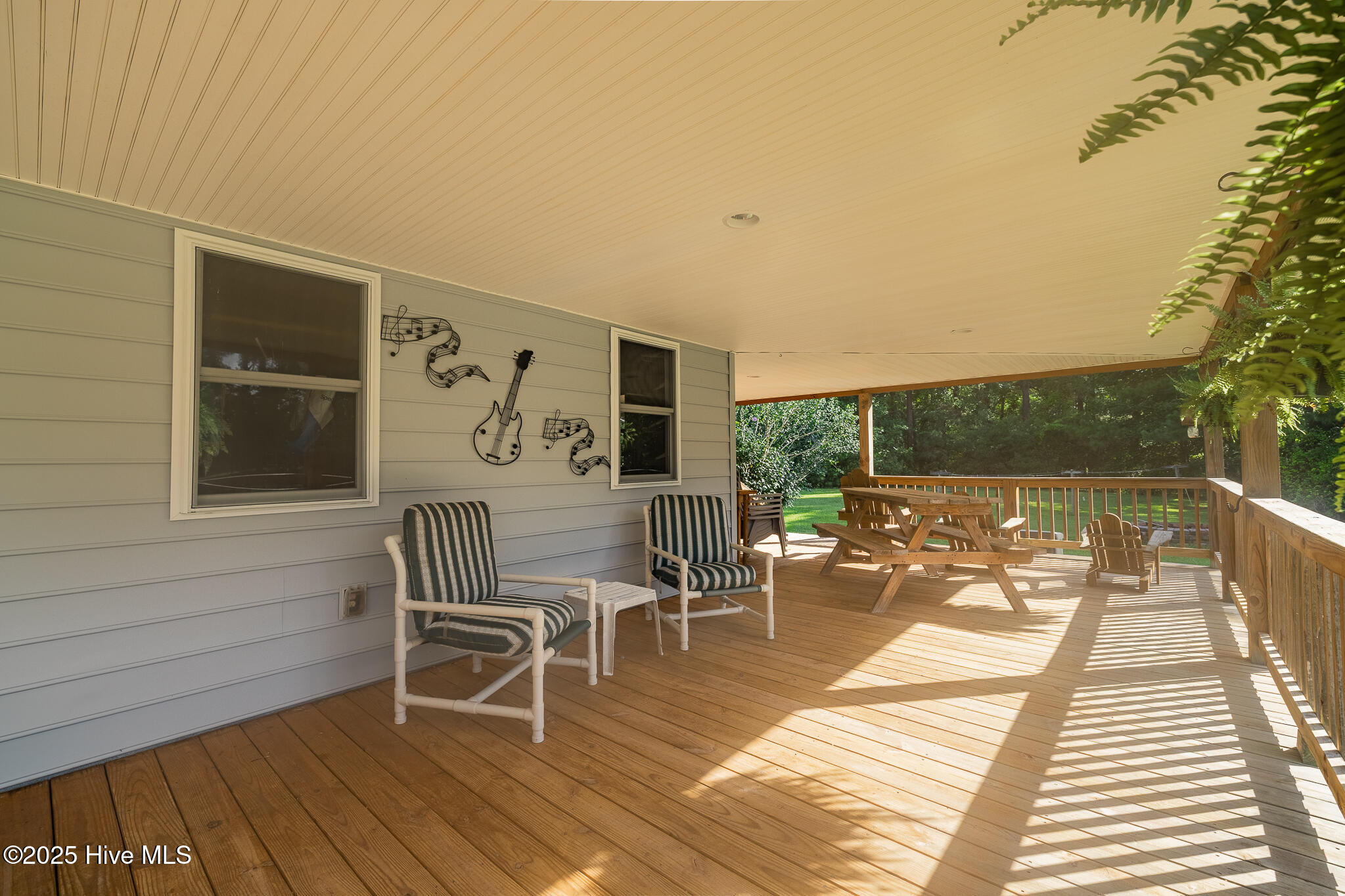 161 Howard Lane Swansboro, NC 28584 - Photo 6 of 56 Front wraparound porch continues along the kitchen/dining side of the home.