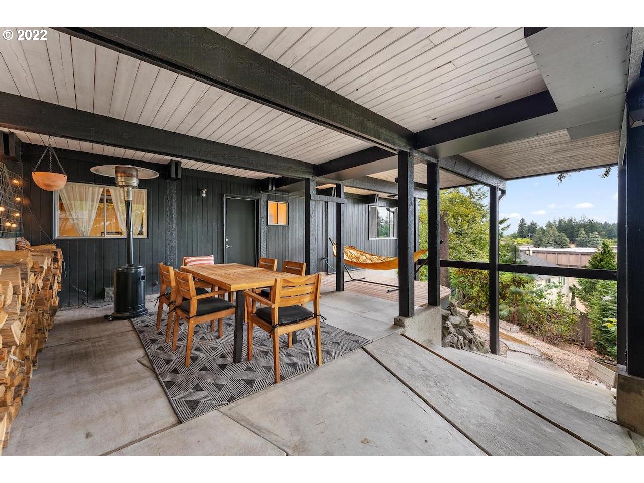 10668 Southwest 41st Avenue Portland, OR 97219 - Photo 23 of 32 a dining room with furniture and a floor to ceiling window
