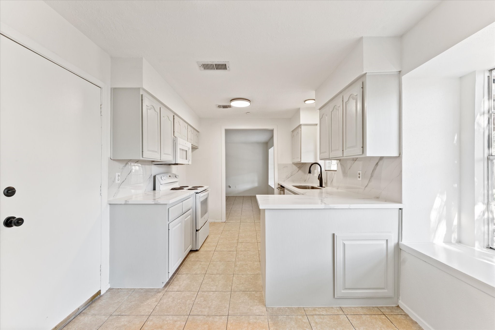23122 Cimber Lane Spring, TX 77373 - Photo 13 of 25 a kitchen with a sink stove and cabinets