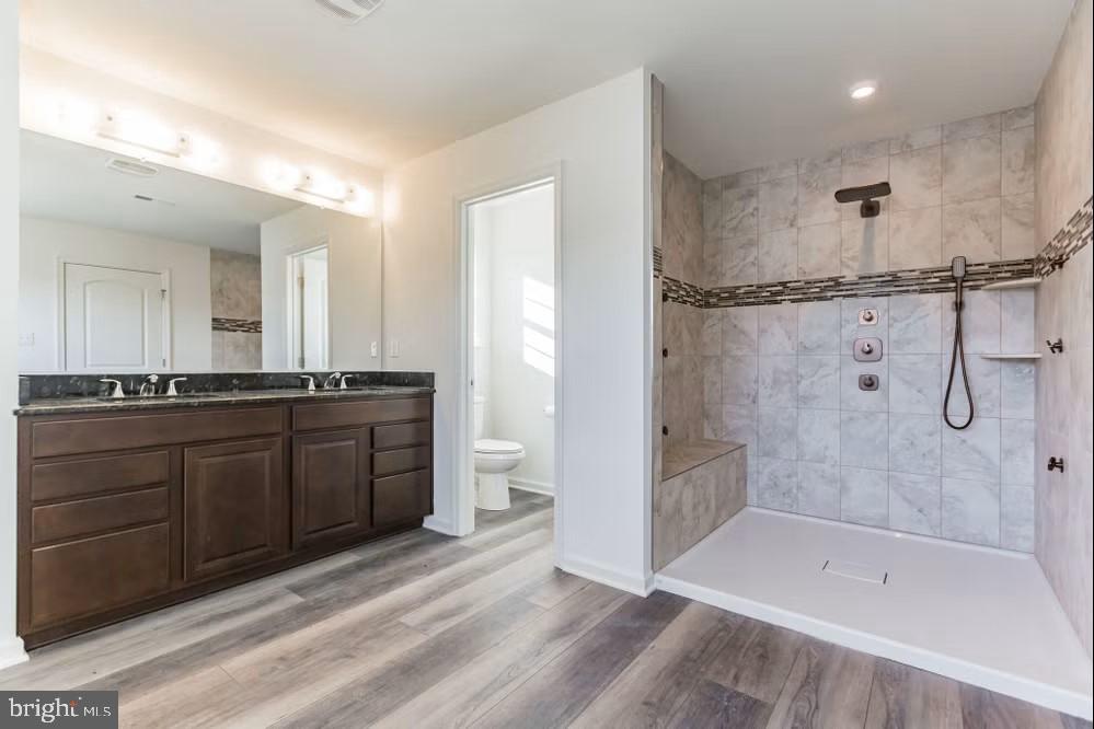 2 Martha Way Warwick, MD 21912 - Photo 34 of 40 a bathroom with a granite countertop sink a mirror a bathtub and a shower