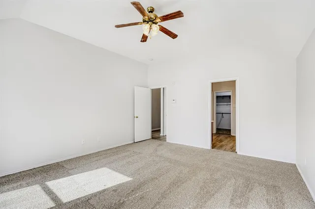 a view of a room with a ceiling fan