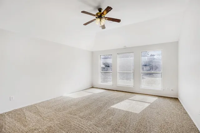 a view of a room with a window and a ceiling fan