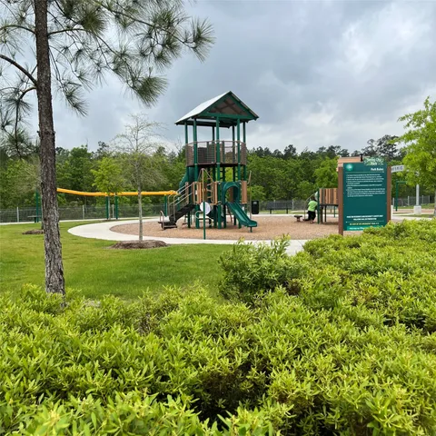 a view of a park with swings and slides