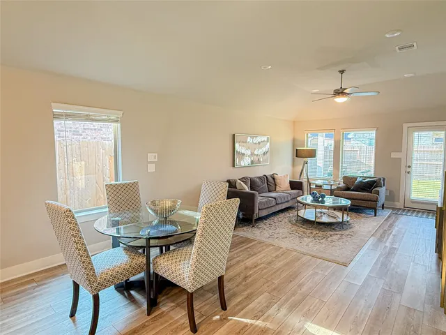 a living room with furniture a flat screen tv and a rug