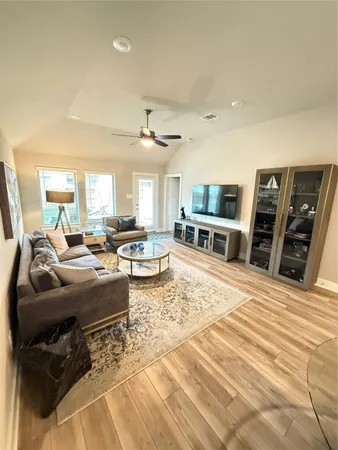 a room with stainless steel appliances a table chairs and kitchen view