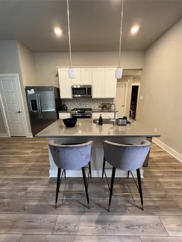 a view of a dining room with furniture and wooden floor