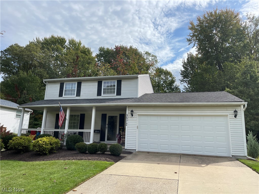View of front of house with a garage and covered porch