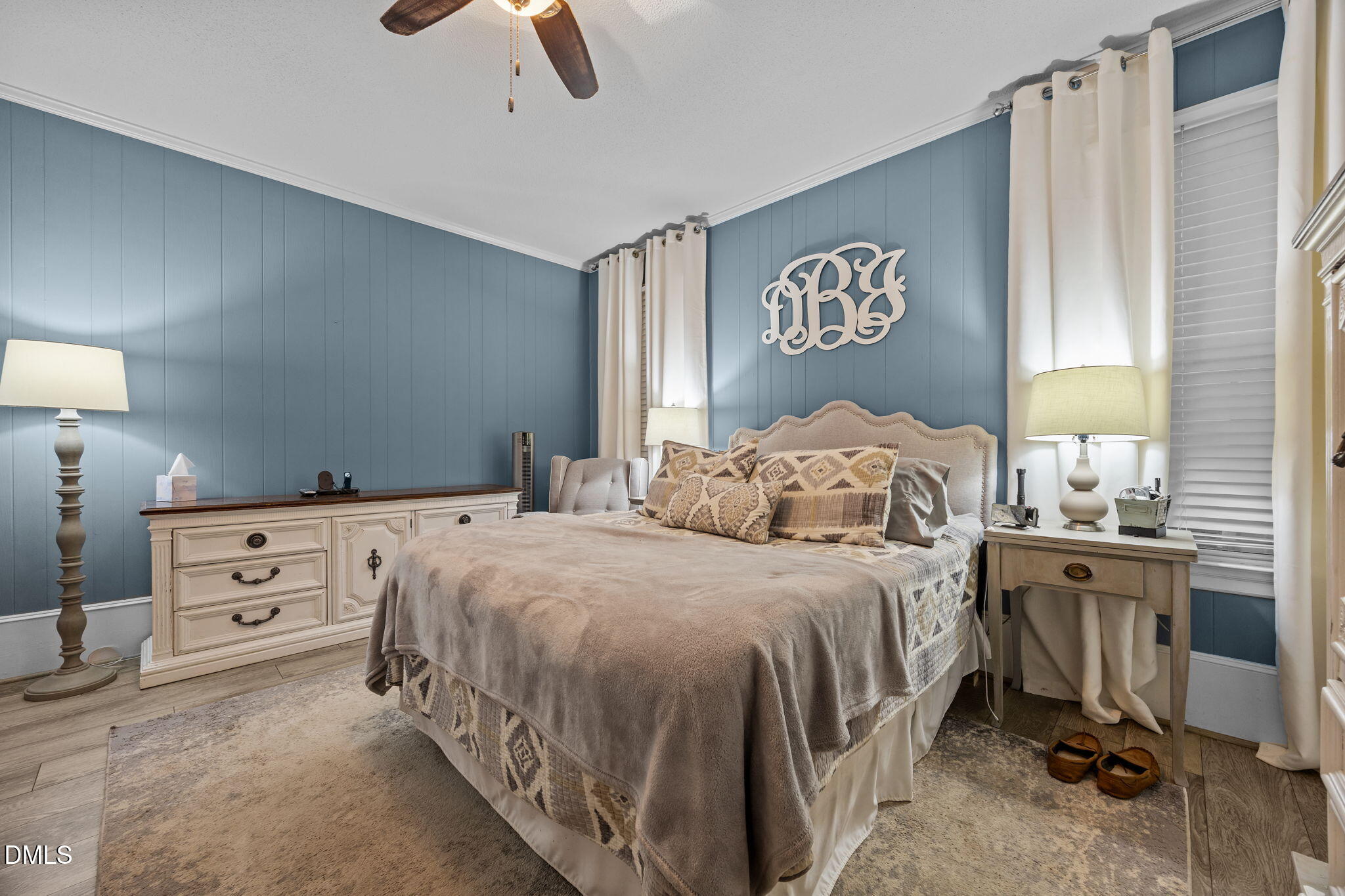 203 North 11th Street Erwin, NC 28339 - Photo 13 of 27 a bedroom with a bed and a chandelier