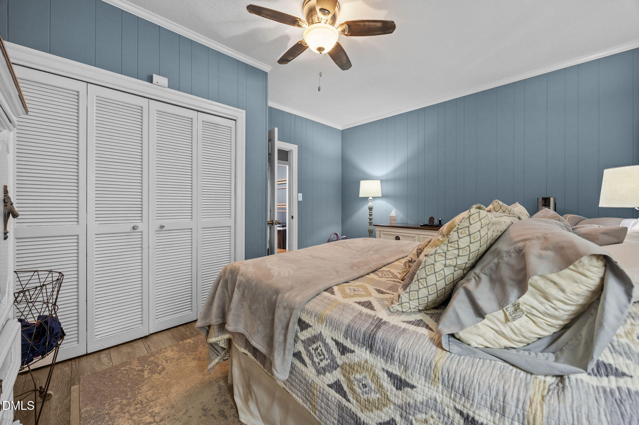 203 North 11th Street Erwin, NC 28339 - Photo 16 of 27 a bedroom with a bed and a chandelier