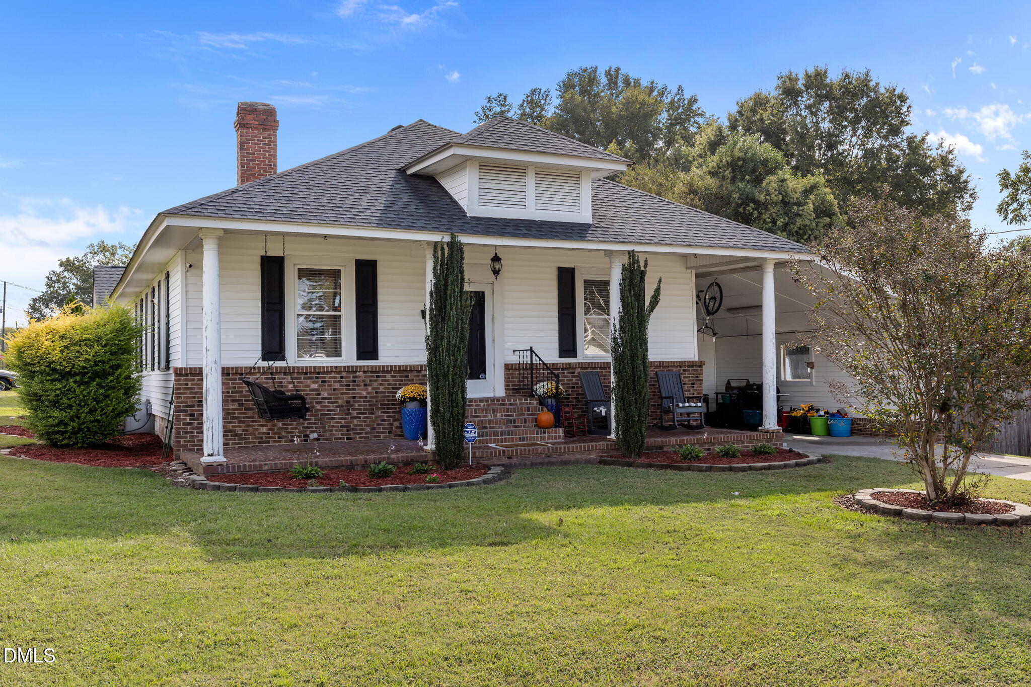 203 North 11th Street Erwin, NC 28339 - Photo 2 of 27 a front view of a house with garden