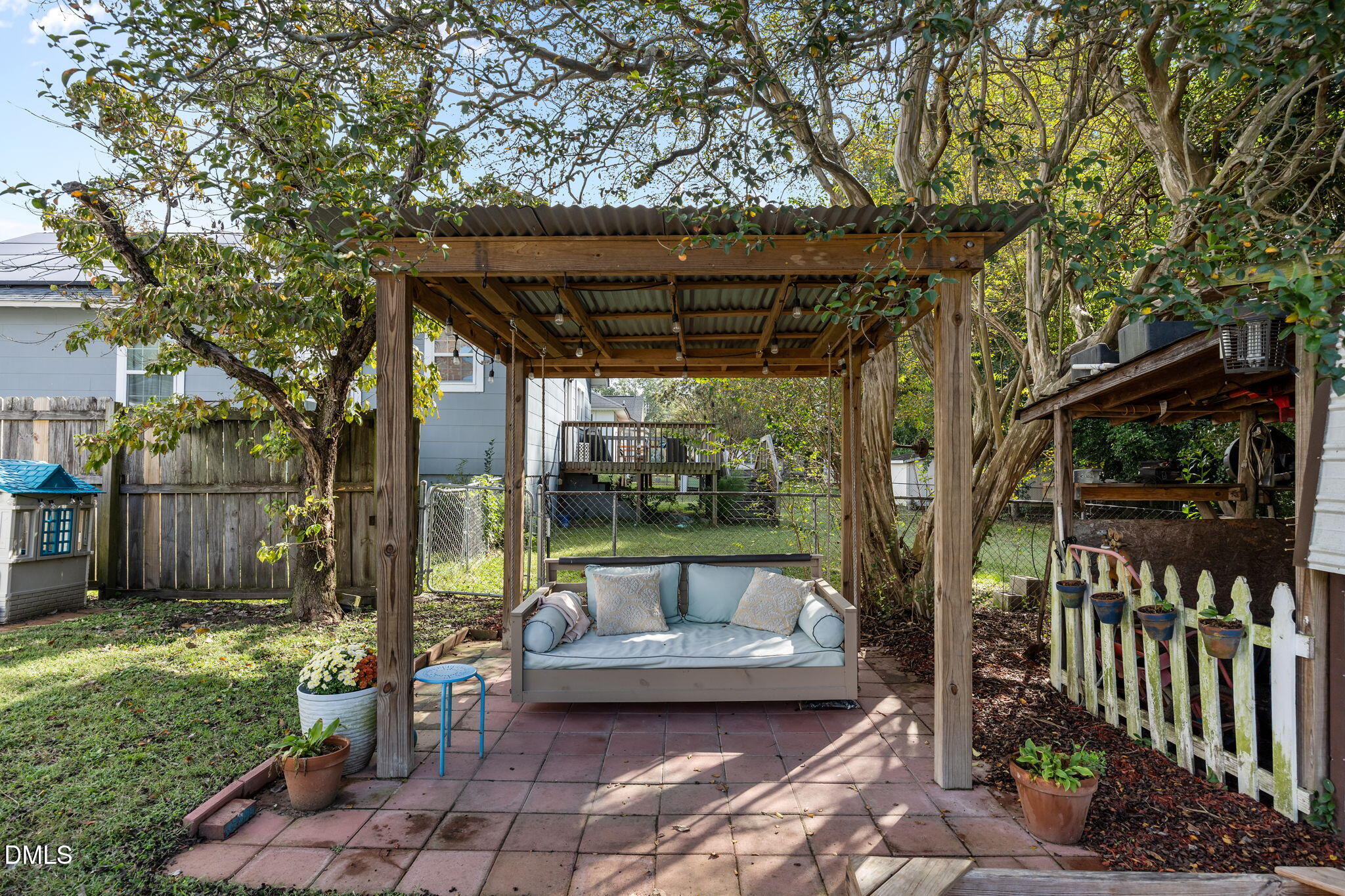 203 North 11th Street Erwin, NC 28339 - Photo 23 of 27 a view of a patio with table and chairs potted plants with wooden floor and fence