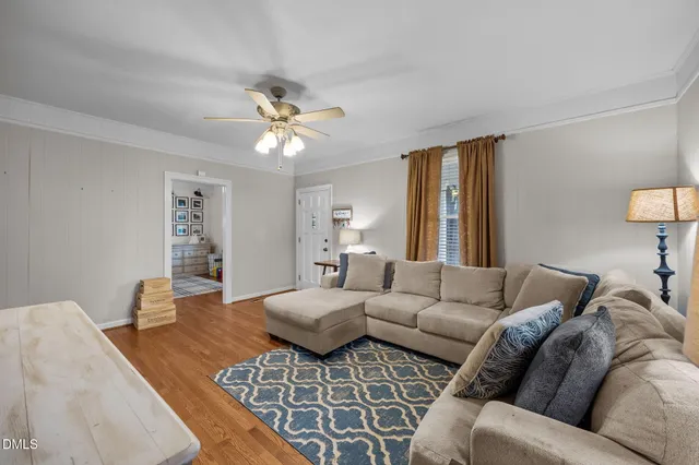 a living room with furniture or couch and a chandelier