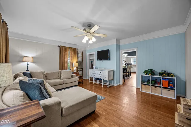 a living room with furniture fireplace and wooden floor