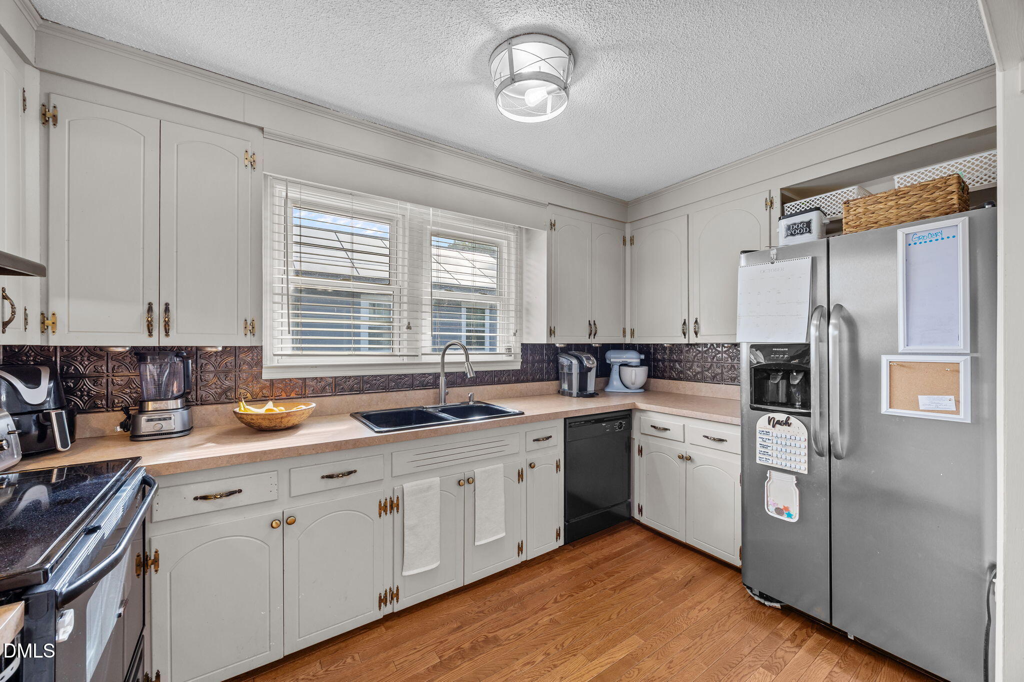 203 North 11th Street Erwin, NC 28339 - Photo 10 of 27 a kitchen with stainless steel appliances granite countertop a sink a stove and refrigerator