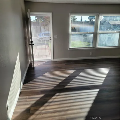a view of entryway and hall with wooden floor