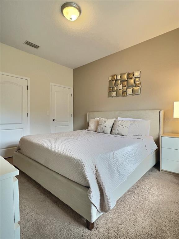 8841 Candy Palm Road Kissimmee, FL 34747 - Photo 21 of 49 a bedroom with a bed and a couch