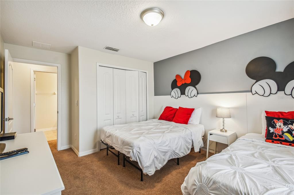 8841 Candy Palm Road Kissimmee, FL 34747 - Photo 25 of 49 a bedroom with two beds and painting on the wall