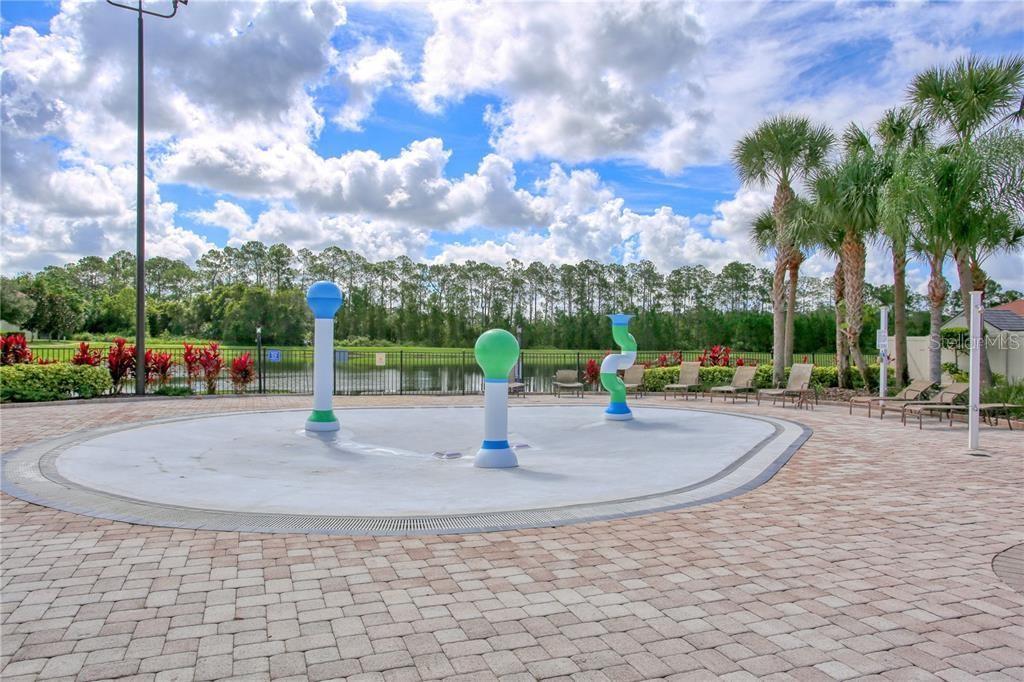 8841 Candy Palm Road Kissimmee, FL 34747 - Photo 48 of 49 a view of a park with swings and slides