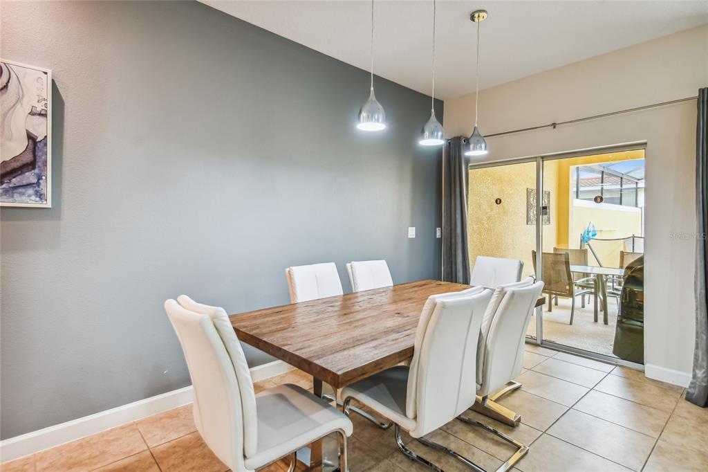 8841 Candy Palm Road Kissimmee, FL 34747 - Photo 9 of 49 a view of a dining room with furniture and wooden floor