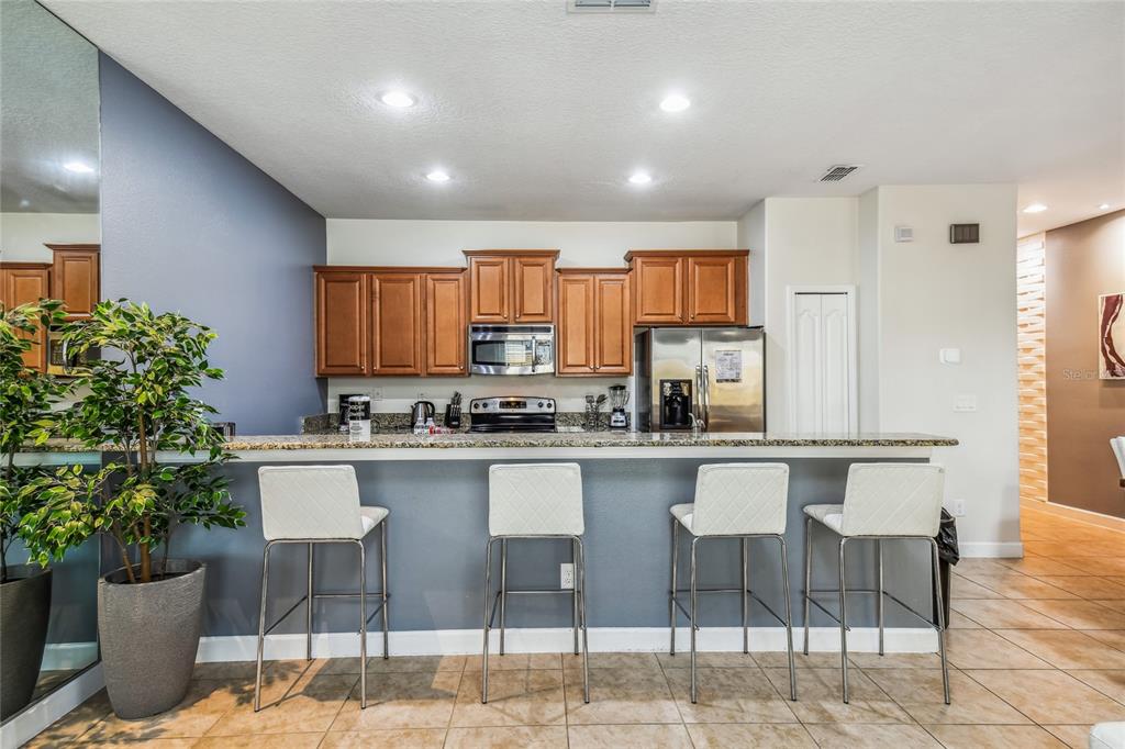 8841 Candy Palm Road Kissimmee, FL 34747 - Photo 10 of 49 a kitchen with a table and chairs in it