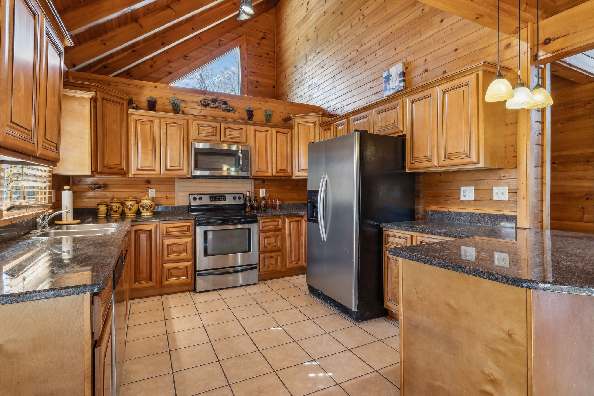 4485 Coconut Ridge Road Smithville, TN 37166 - Photo 10 of 33 a kitchen with granite countertop a refrigerator and a stove top oven
